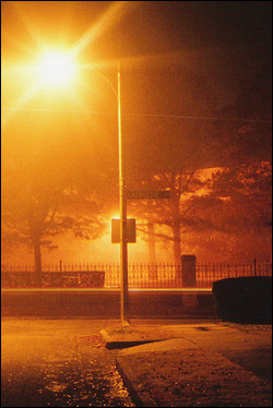 A foggy street at night.