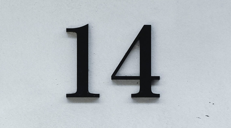 Crisp, black lettering on a white-wall. Lettering: "14"