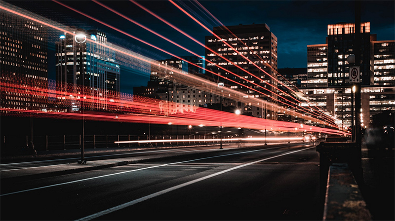 Time lapse of a passing car at night.