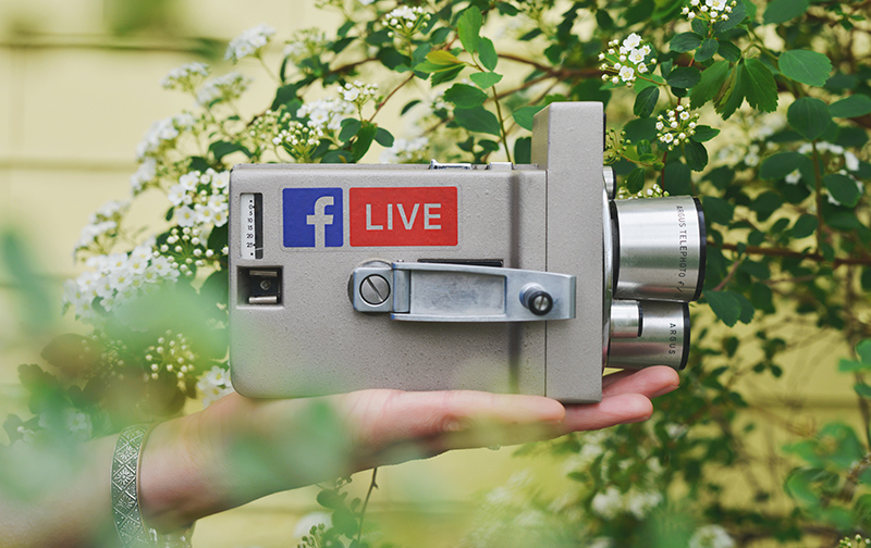 Old camera with Facebook Live sticker on side.