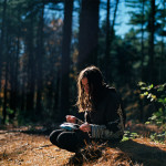 A woman reading in the woods