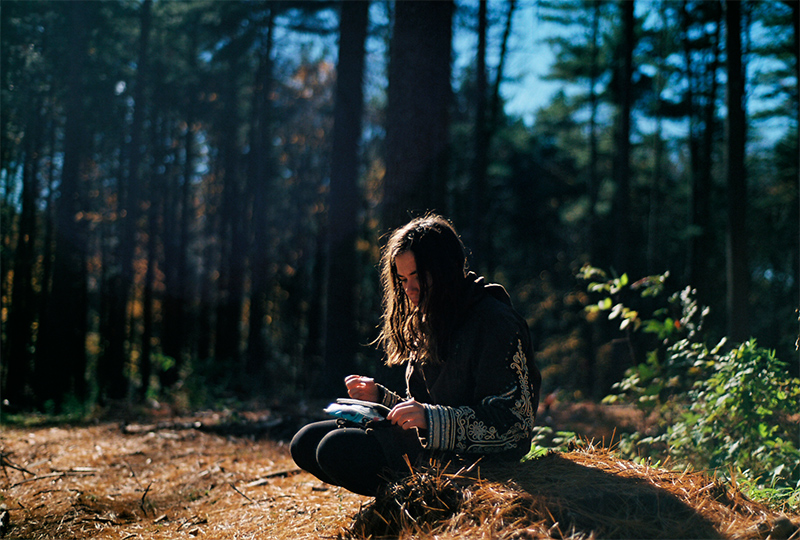 A woman reading in the woods