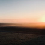 Sunrise through fog.