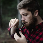 Guy lighting a pipe