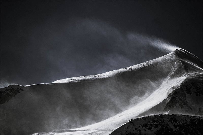 Snow blowing off a mountain top