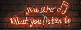 Neon sign reading "You are what you listen to."