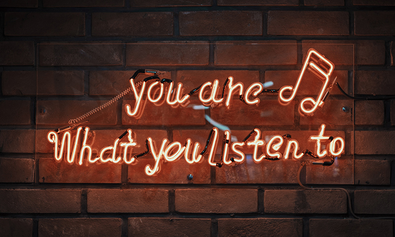 Neon sign reading "You are what you listen to."