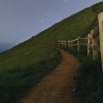 Path along a fenceline on a hill.