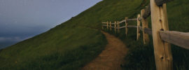 Path along a fenceline on a hill.