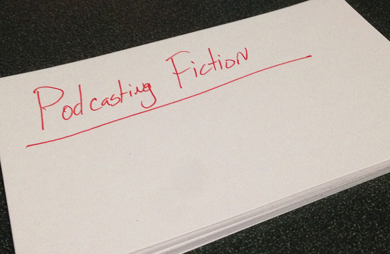 Stack of Note Cards. Top One Reads "Podcasting Fiction"