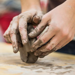 Hands sculpting clay