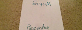 Sign reading "Writing" and "Recording" on opposite sides.