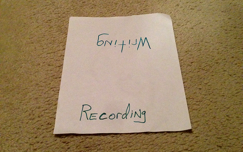 Sign reading "Writing" and "Recording" on opposite sides.