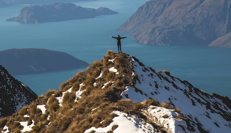 Woman standing on mountain summit