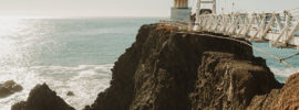 Lighthouse at end of walkway.