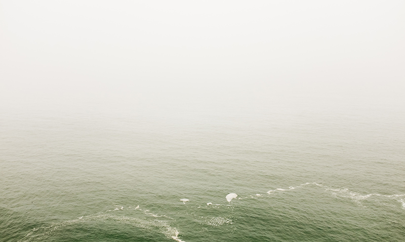 Ocean disappearing into fog.