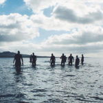 People wading into the ocean.