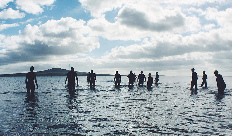 People wading into the ocean.