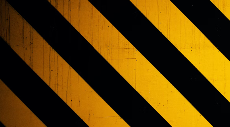 Close-up of a yellow and black striped warning sign.