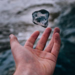 Hand tossing a stone in the air