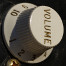 Volume knob on an electric guitar.